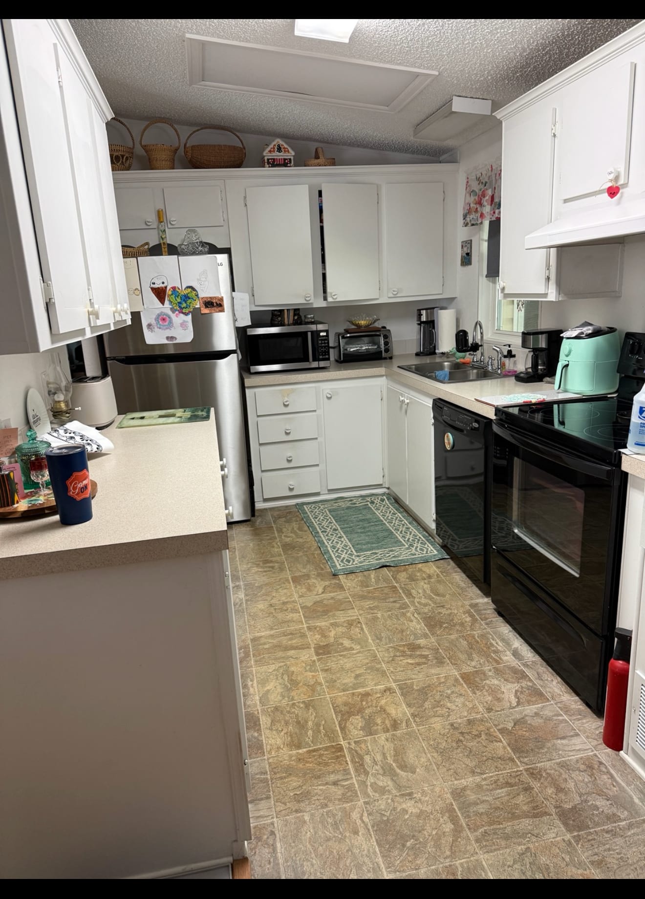Kitchen before repainting — white cabinets worn from years of cleaning in Ocala, FL