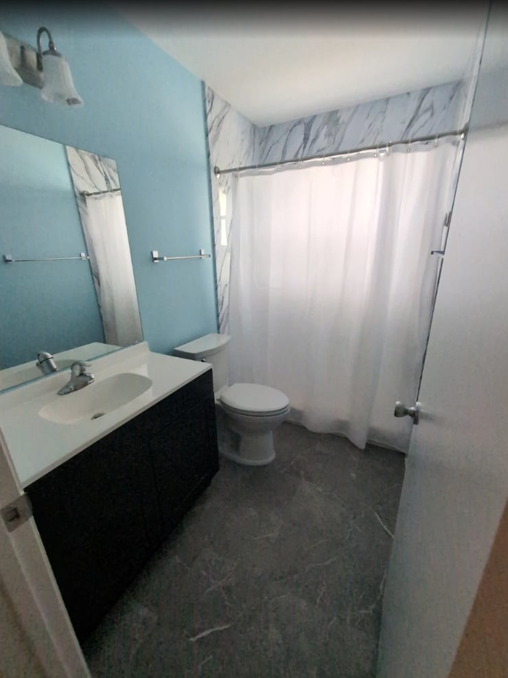 Bathroom with freshly painted blue walls and a dark vanity in Ocala, FL